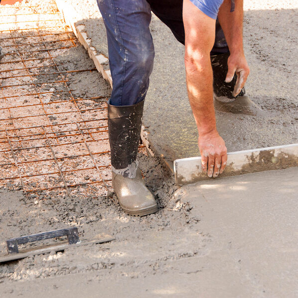 workers installing cement in the floor